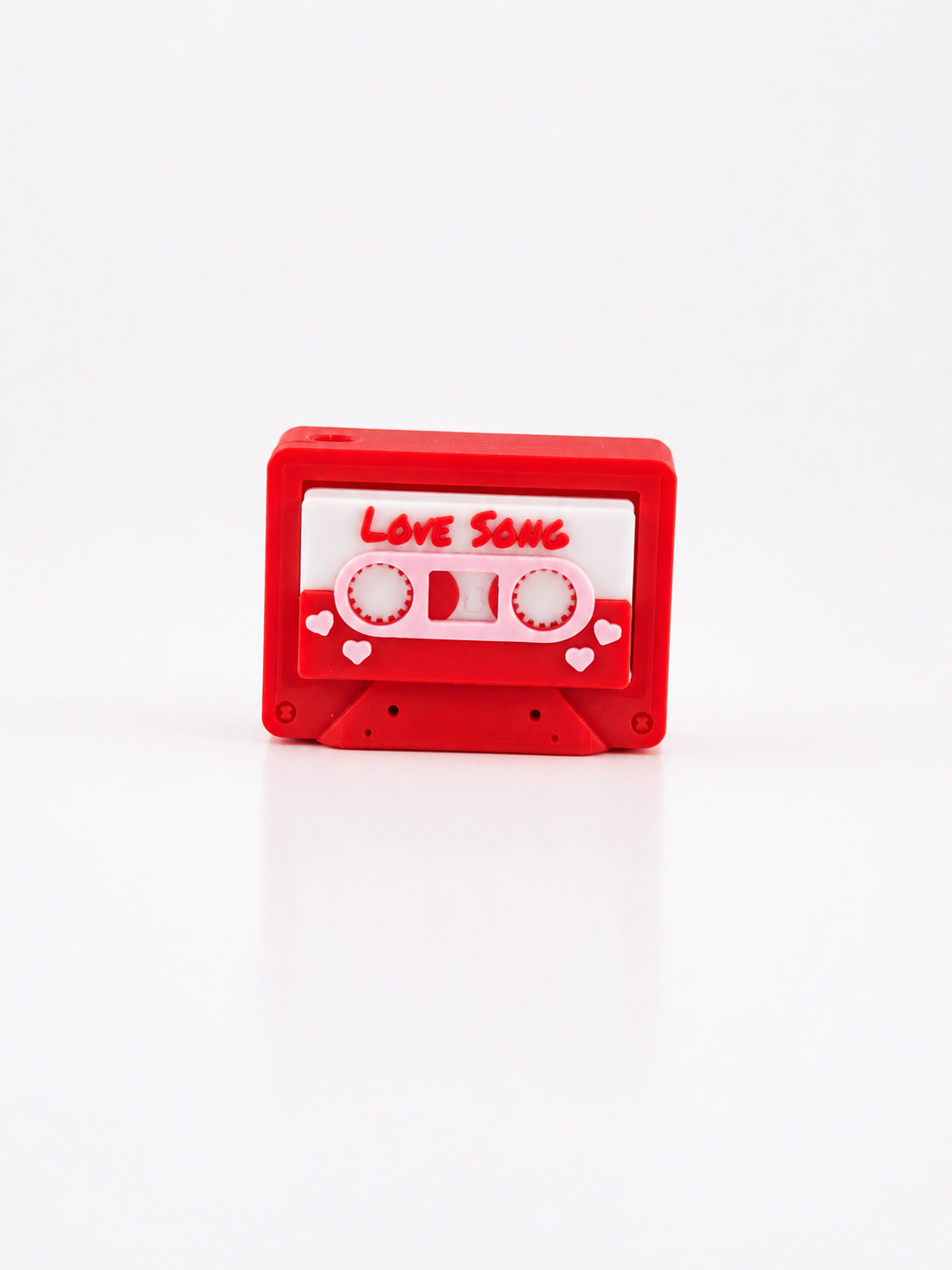 cassette tape fidget clicker that says Love Song in red, pink, and white.