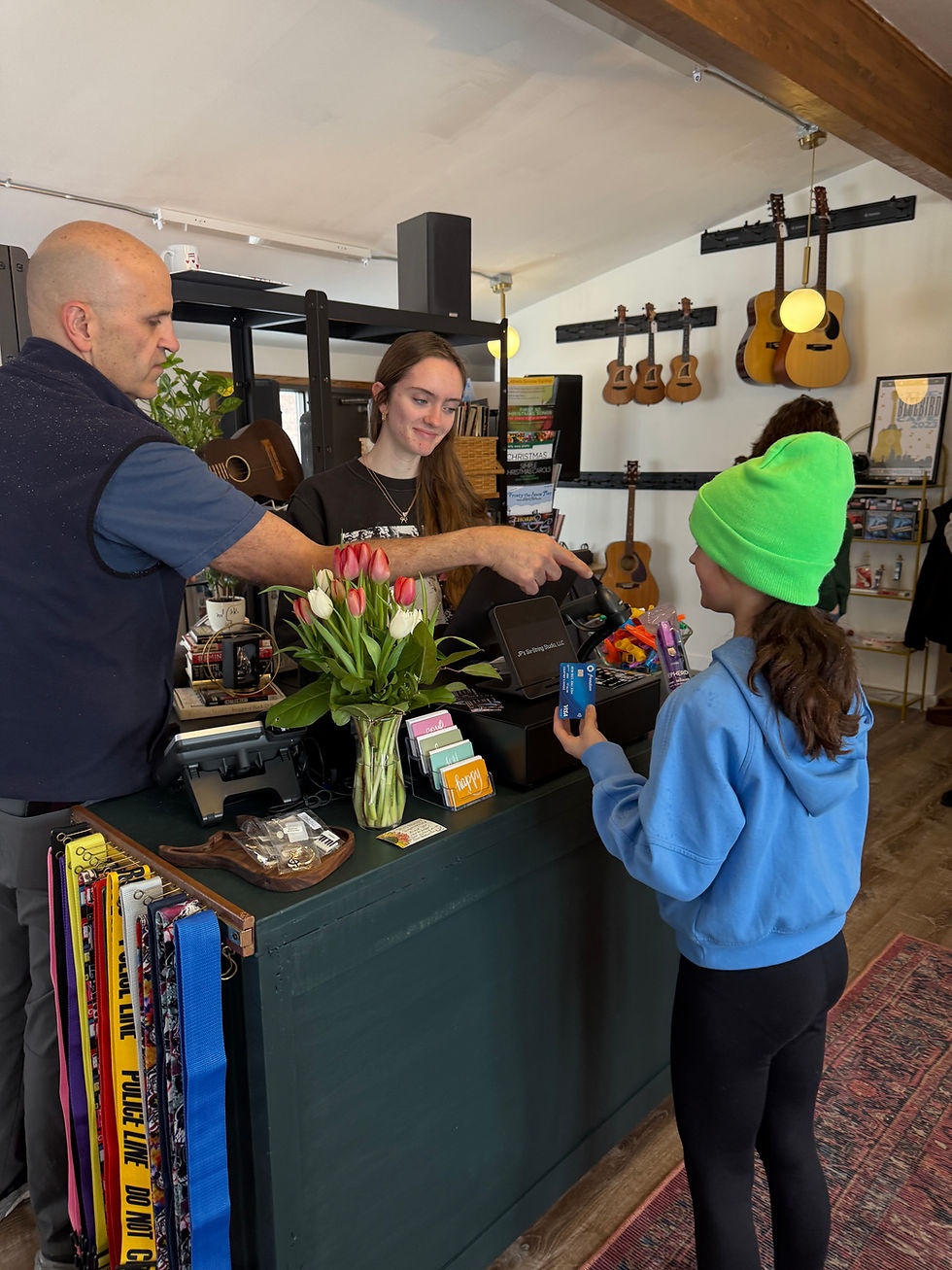 John Steltz (left) and daughter (middle) ring-in one of their first customers.