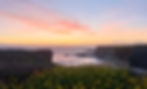 a soothing pink and yellow sky over a cove on the Santa Cruz coast symbolizing the transformative space offered by Gaia Somasca, LMFT.