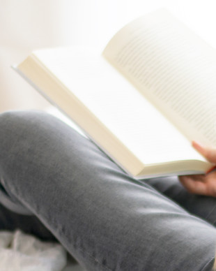 Woman Reading in Bed