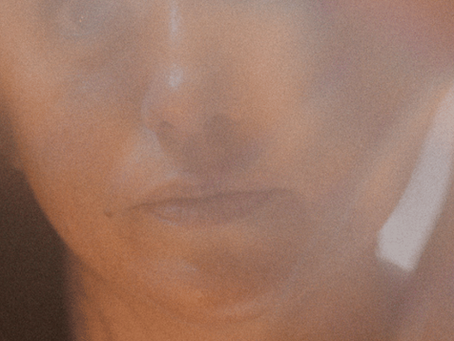 Close-up portrait in dark warm tones, evoking the raw emotional intensity of rejection sensitive dysphoria in ENM and neurodivergent relationships