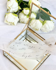 Flowy and modern calligraphy on vellum strips in a luxury glass box