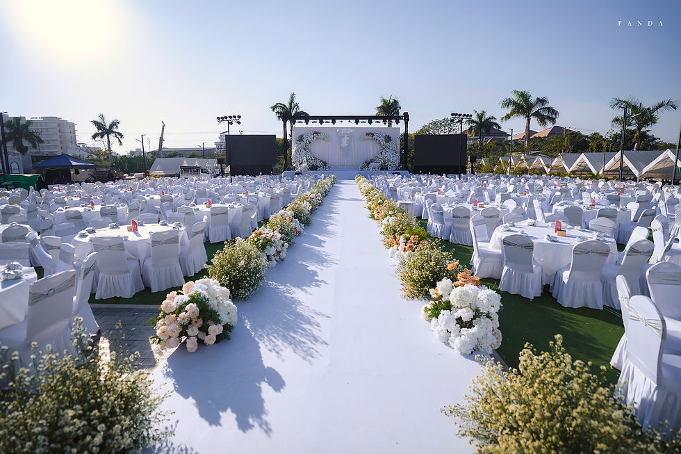 Wide angle view of a beautifully decorated lawn wedding venue in Mandalay with elegant lighting and floral arrangements