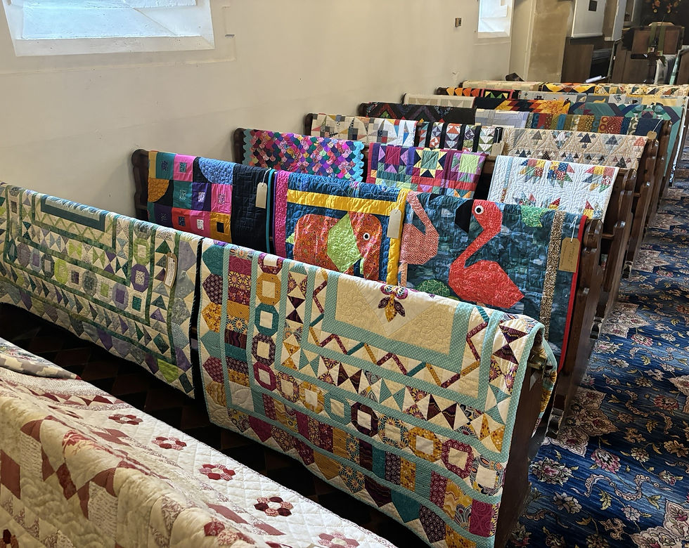 Quilts on pews looking towards the altar