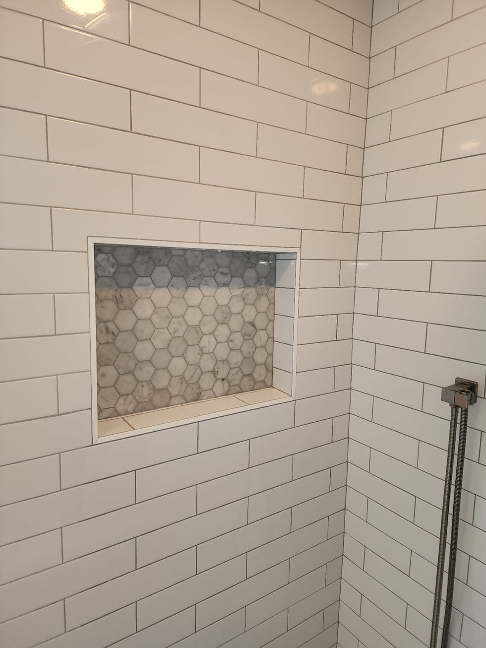 Custom shower wall tile installation detail.
