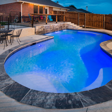 kidney shaped pool in small backyard