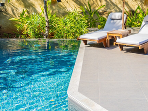 Custom Pool with Tropical Plants and Two Lounging Chairs