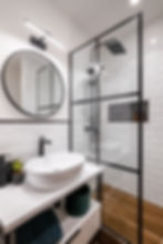 White Bathroom with Strong Black Accents on Hardware and Decor