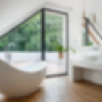 Bathroom with Large White Bathtub and a Large Window