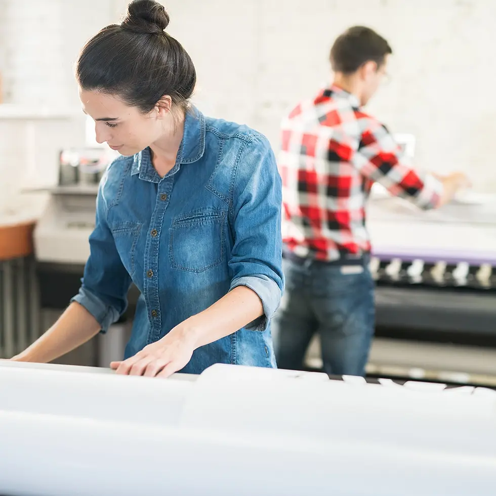 two-employees-working-with-large-format-printer.webp