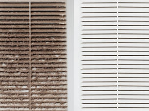 A close-up of a dirty furnace air filter blocking airflow compared to a clean air filter