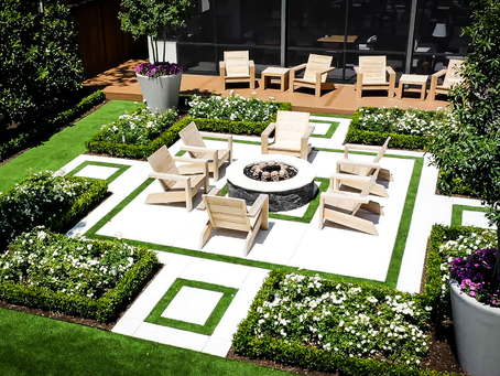 Above-level view of a luxury stone patio with integrated fire feature