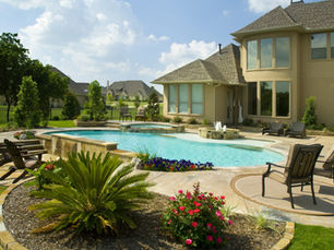 Backyard with pool and adjoining spa with patio seating