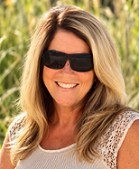 Sunlit Beachside Portrait of a Smiling Woman.png