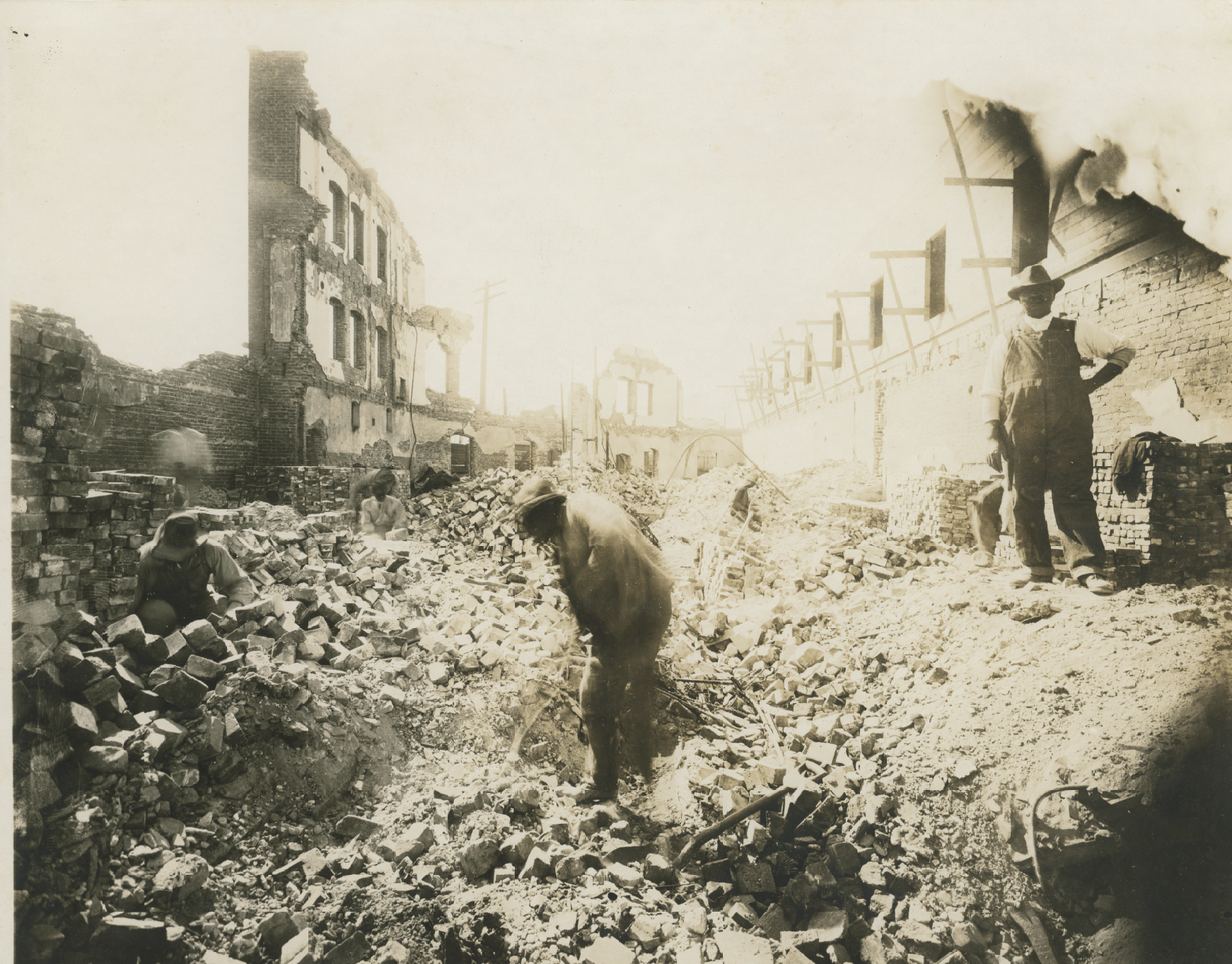 smaller 5 men sifting through rubble