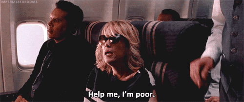 A gif from the movie bridesmaids where Annie's character says "help me, I'm poor."