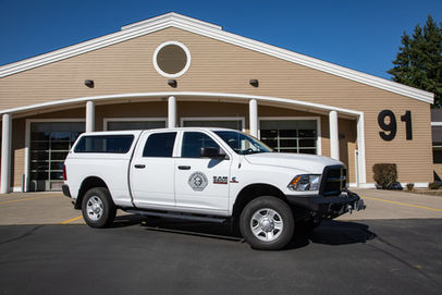 white truck parked in front of fire station