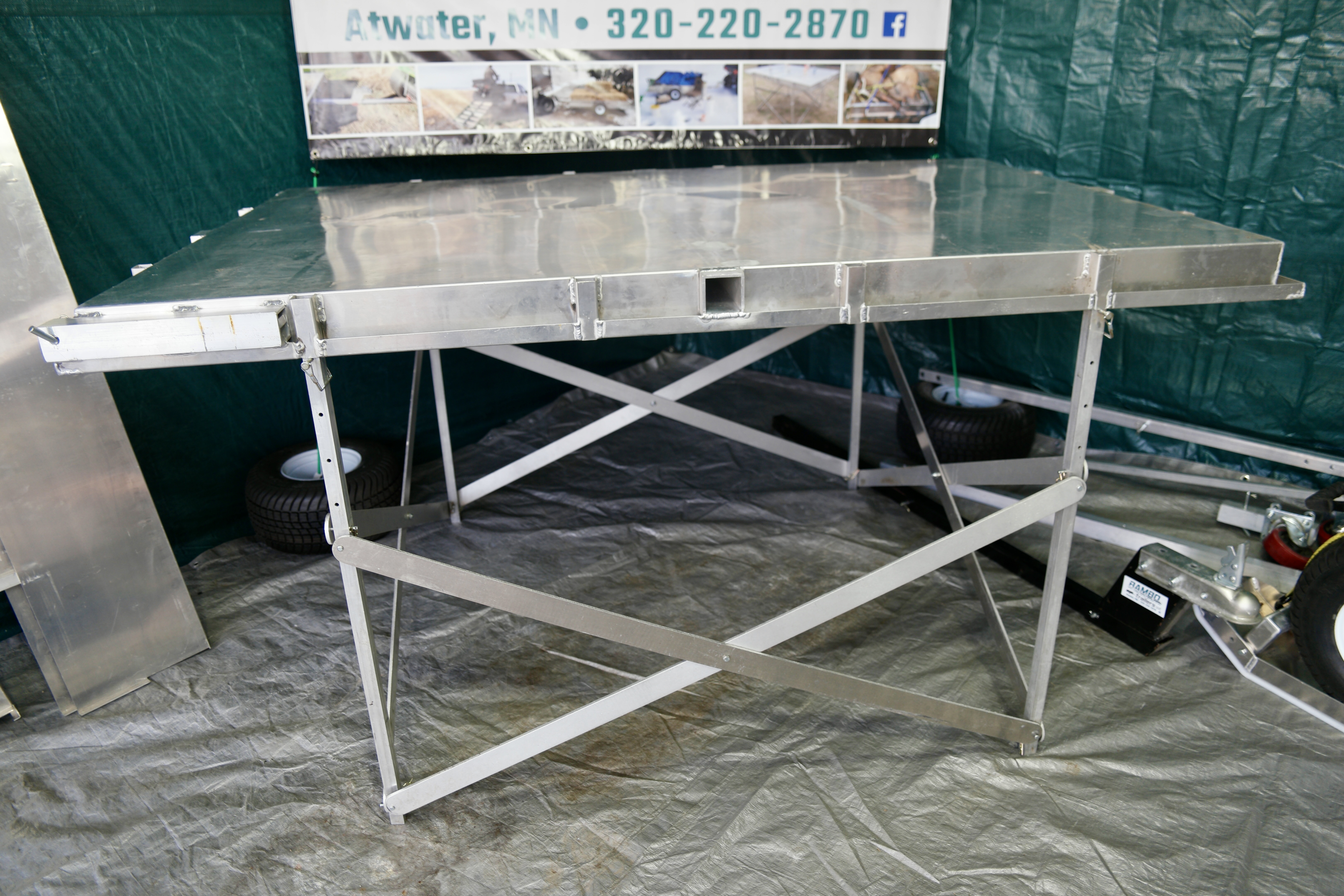 Rambo Trailer, an aluminium multi-use on and off road trailer set up as a table. 