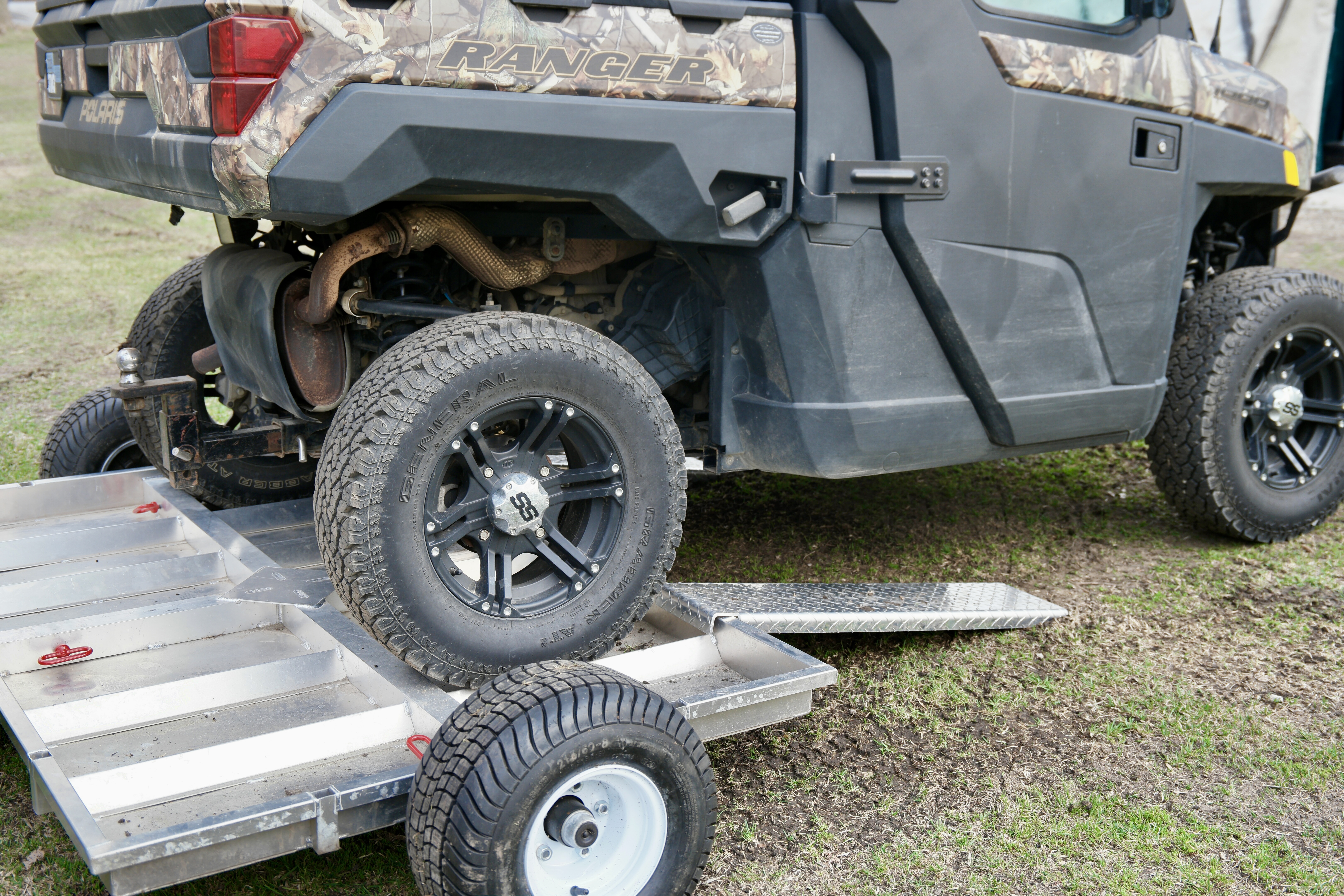 Rambo Trailer, an aluminium multi-use on and off road trailer with an EV being backed up onto it. 