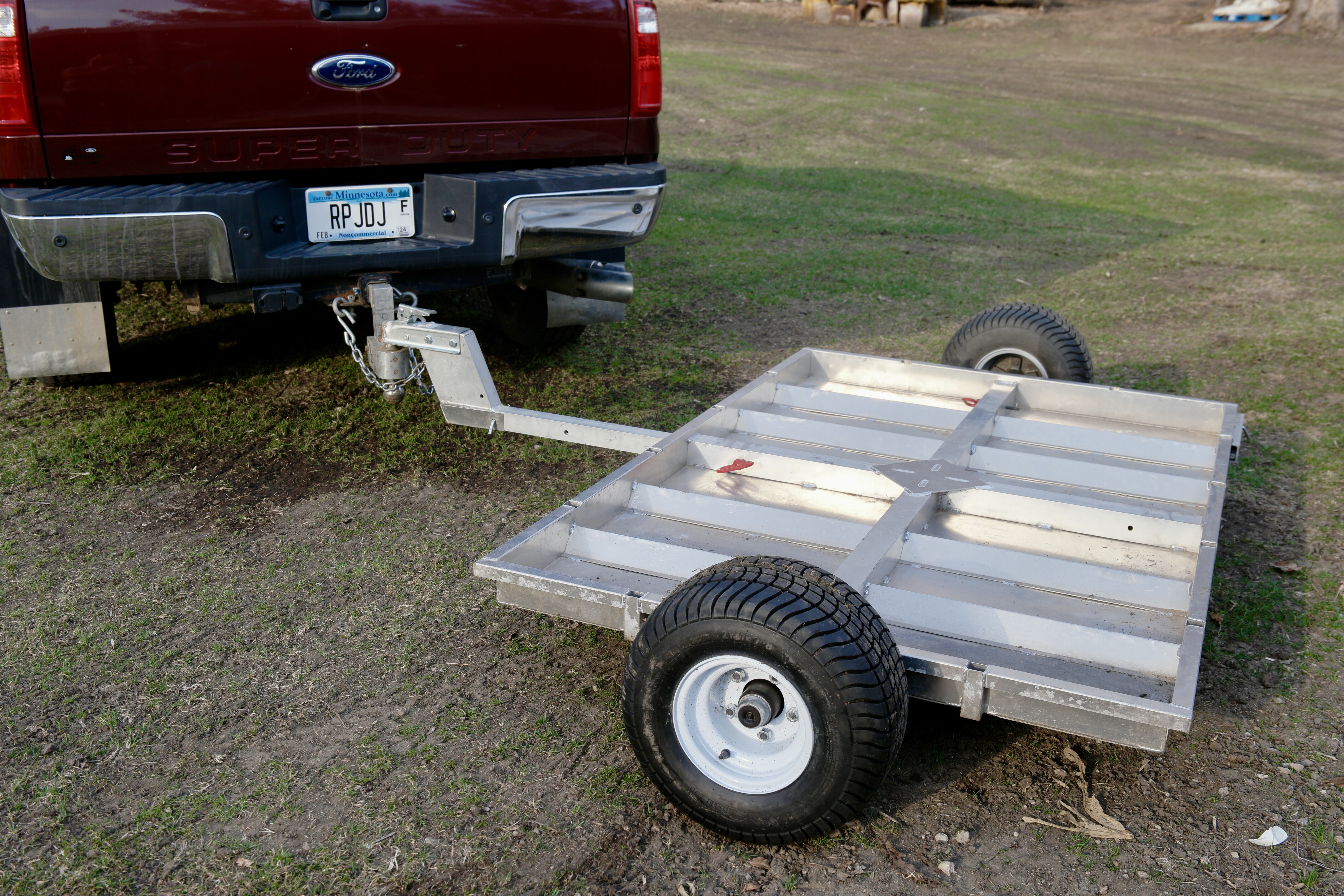Rambo Trailer, an aluminium multi-use on and off road trailer, attached to a pickup truck with a ball hitch. 