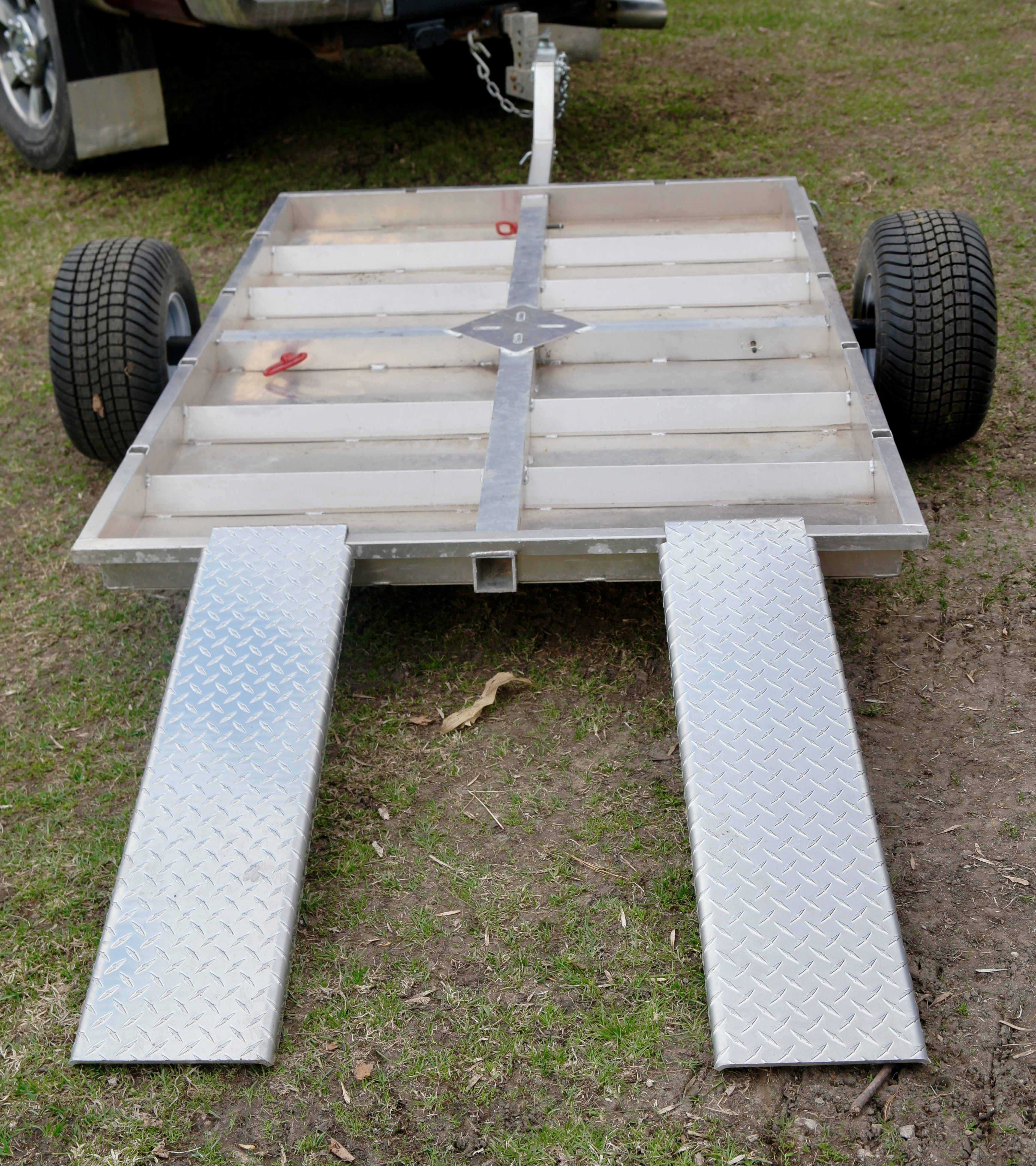 Rambo Trailer, an aluminium multi-use on and off road trailer parked with four wheeler ramps attached