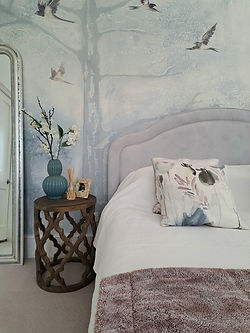 Wallpaper feature mural blue with OKA wooden bedside and lamp
