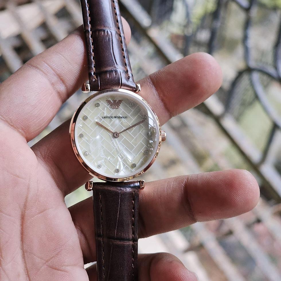 Armani watch held in hand