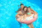 happy-family-with-inflatable-ring-relaxing-swimming-pool.jpg