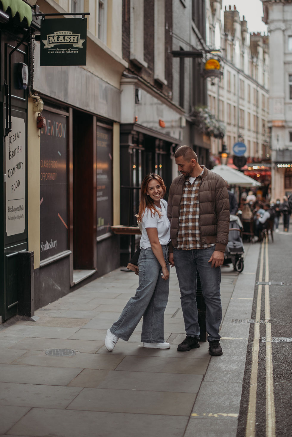 a man looks to his wife and a wife looking straight to the camera