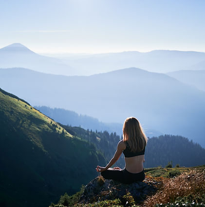 brunette-is-meditating-lotus-pose-mountains.jpg