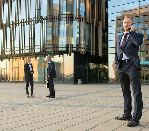 successful-businessman-wearing-office-suit-talking-mobile-phone-outdoors-businesspeople-ci