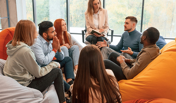 psychologist-is-sitting-listening-group-people-are-having-therapy-meeting-together.jpg