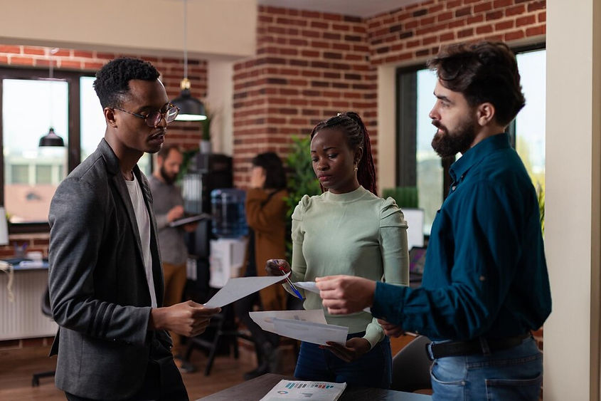 multi-ethnic-businesspeople-discussing-business-collaboration-after-analyzing-marketing-st