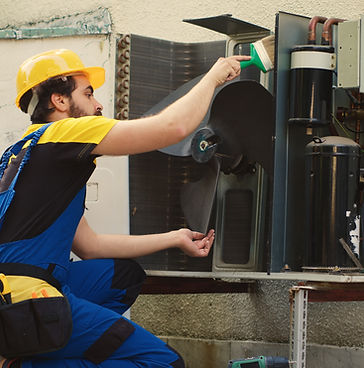 hvac-engineer-dusting-blower-fan.jpg