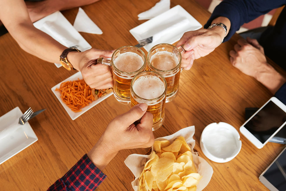 top-view-three-unrecognizable-friends-toasting-with-beer-mugs.jpg