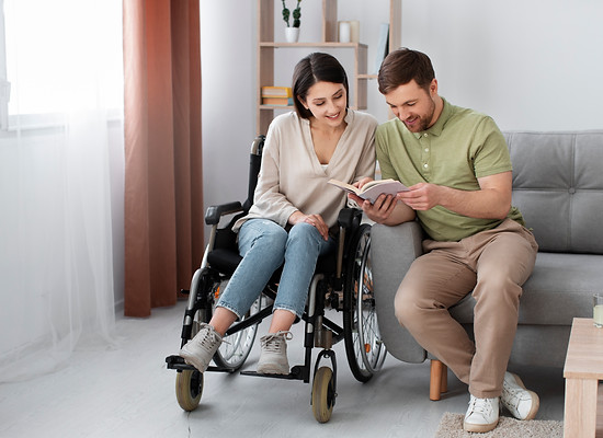 young-adult-reading-with-disabled-friend.jpg
