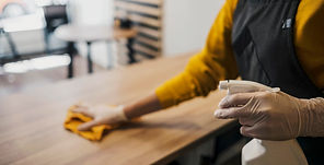side-view-female-barista-cleaning-table-while-wearing-latex-gloves.jpg