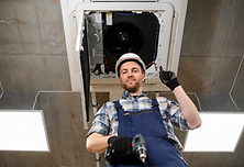 hvac-technician-repairing-air-conditioner.png