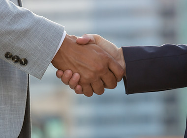 businesspeople-standing-city-street-shaking-hands.jpg