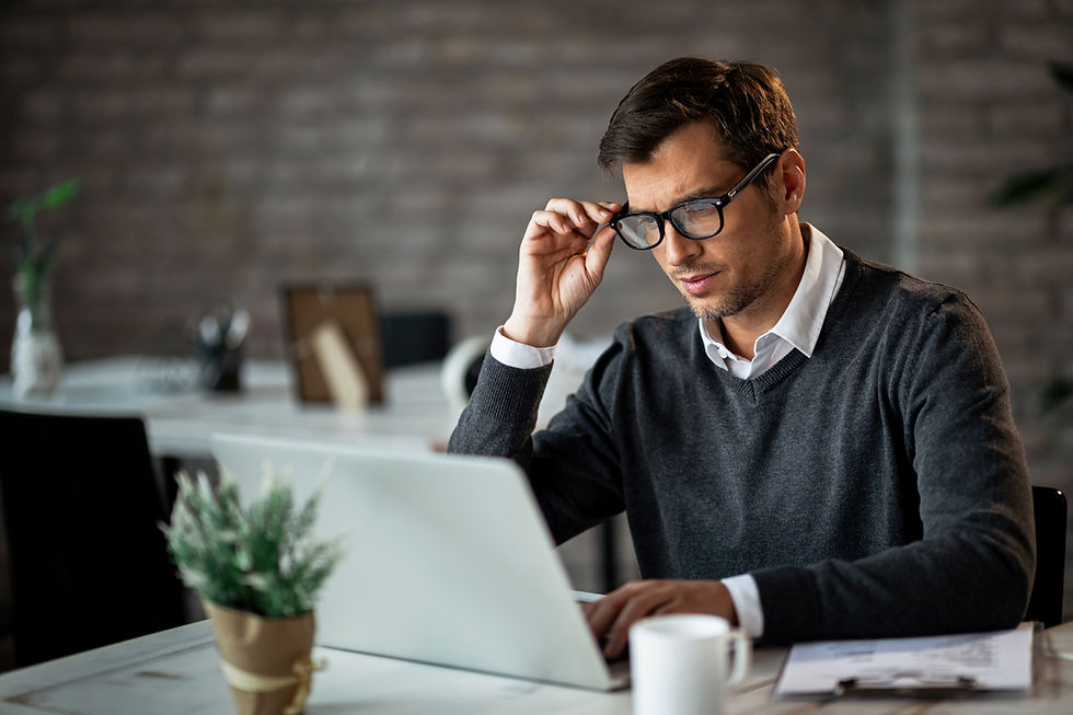 mid-adult-businessman-using-computer-while-working-office.jpg
