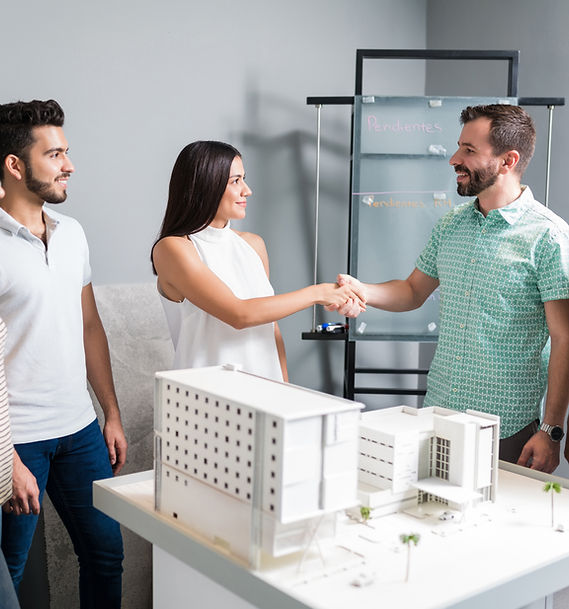 business-partners-shaking-hands-with-engineer-by-architectural-model-meeting.jpg