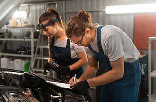 male-female-mechanics-working-shop-car.jpg