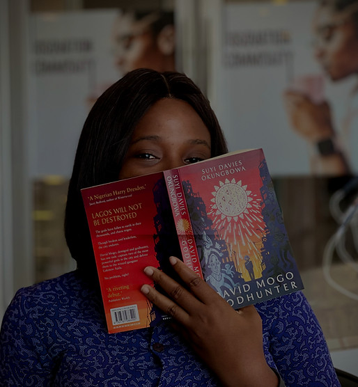 A lady holding book to cover her face_edited.jpg