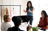 diverse-group-women-business-meeting-women-are-discussing-fashion-with-clothing-racks-back