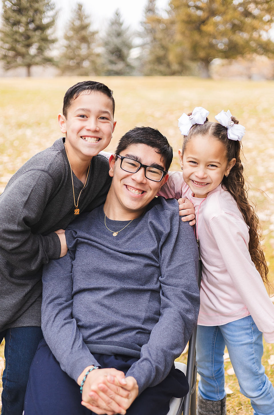 Three siblings smiling by VB Portraits