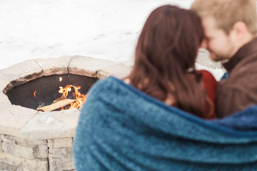 A couple sitting around a fire in winter VB Portraits LLC