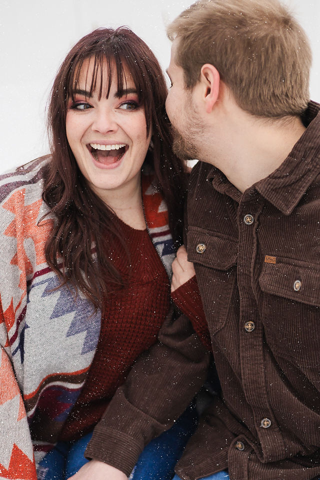 A couple laughing together A couple roasting marshmallows VB Portraits LLC