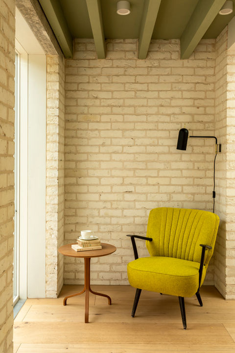 Kitchen design in brick side return extension. Vintage yellow seat corner with side table