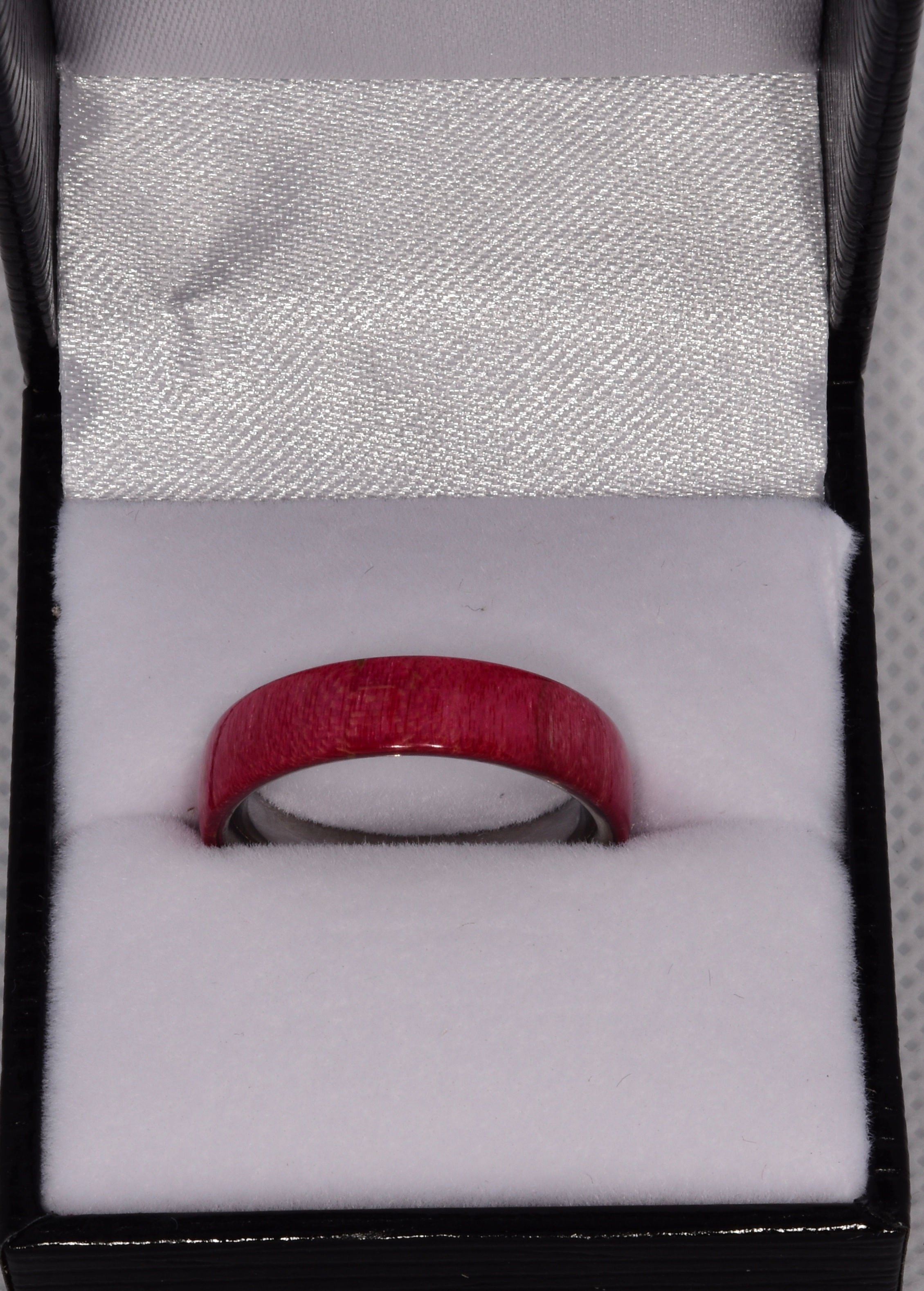 Fuchsia dyed curly Maple with stainless steel ring core.