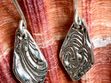 Handmade pair of fine silver earrings with wave texture, inspired by the sea